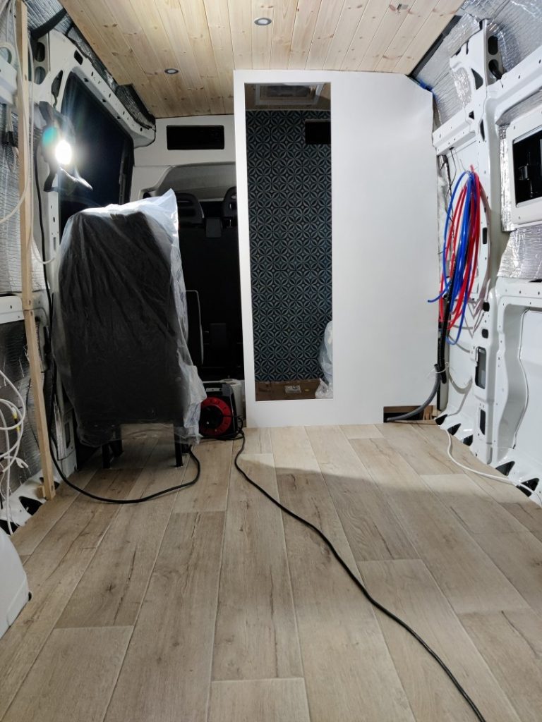 The completed wood-effect vinyl floor laid in the van